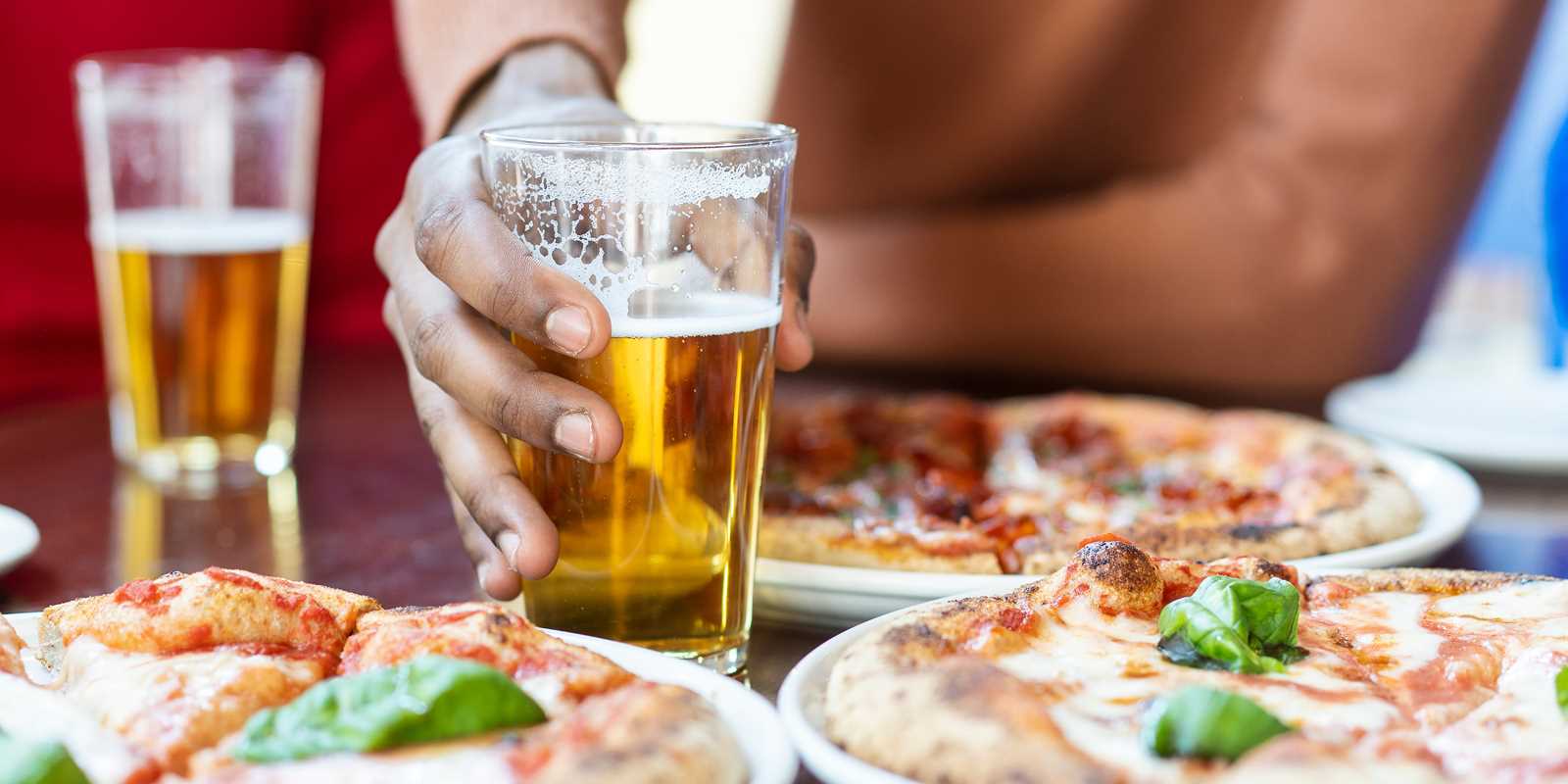 Guests enjoying a variety of pizzas and beers at Black Pizza in Atlanta.